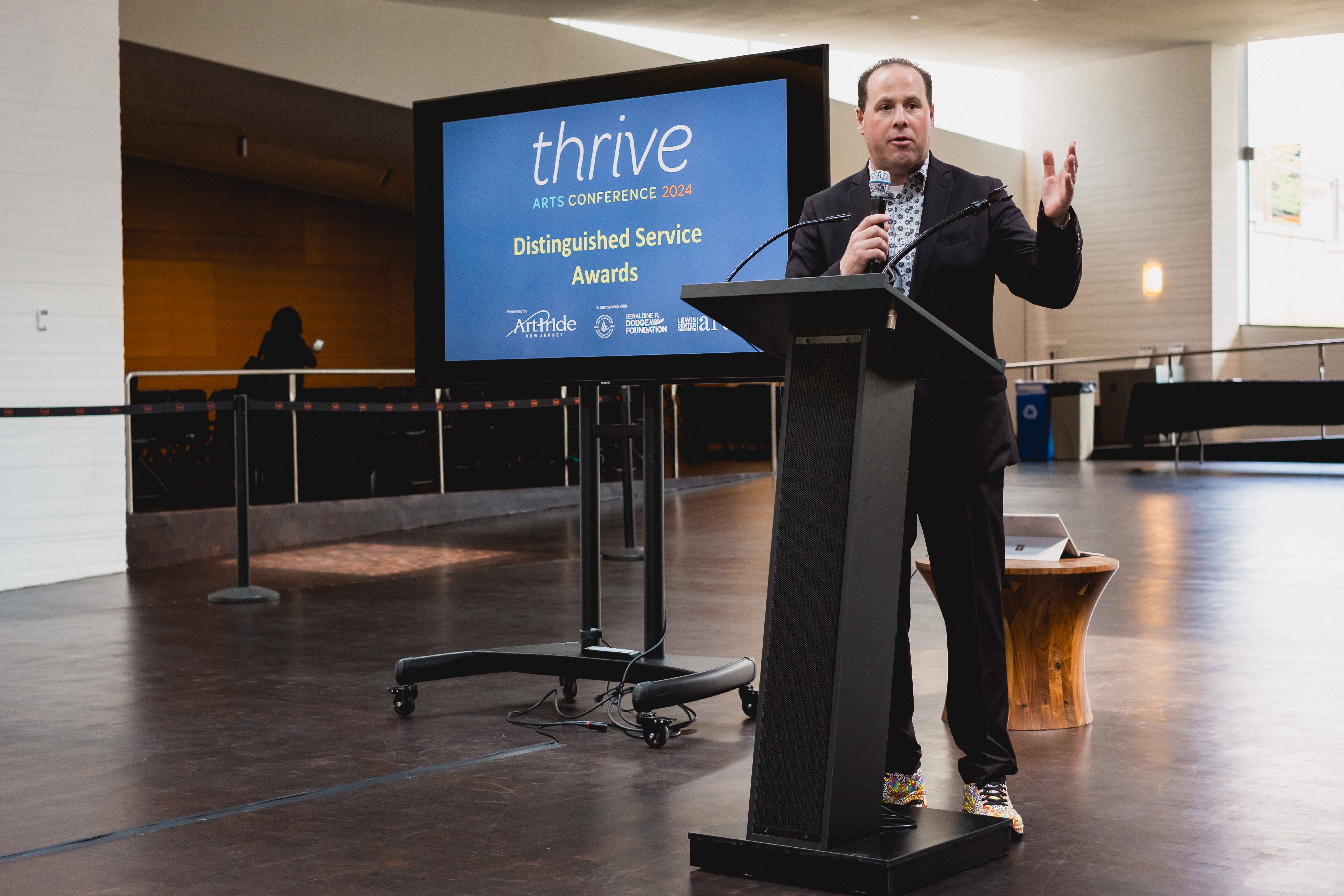 Adam Perle speaking at the Thrive Arts Conference in 2024