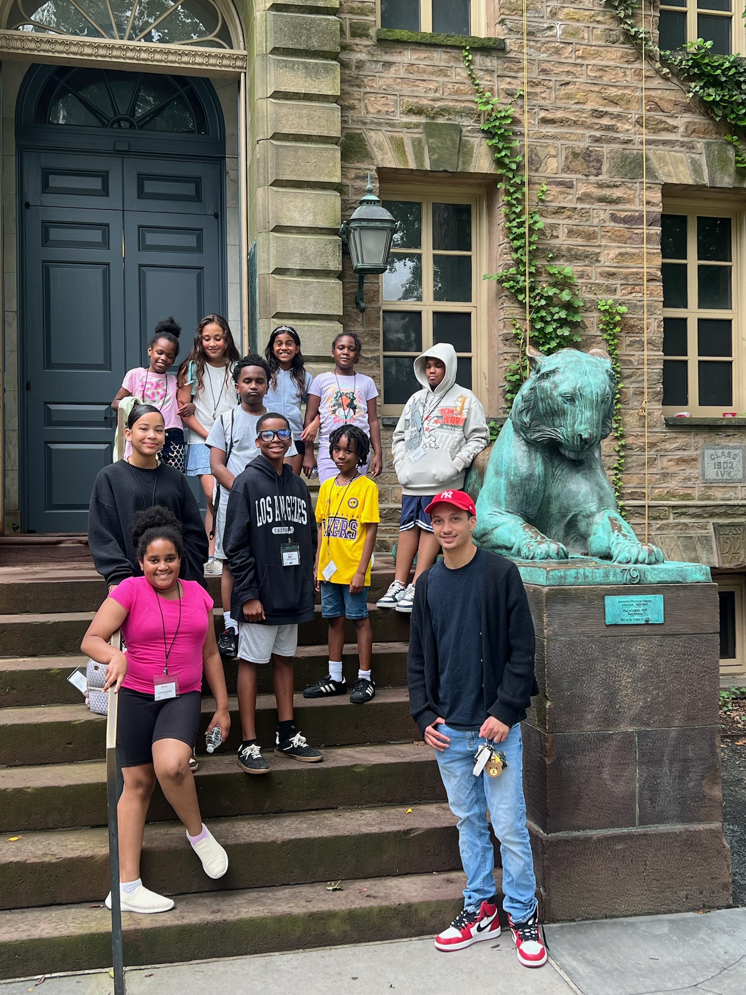 Group of kids and staff standing on a stoop