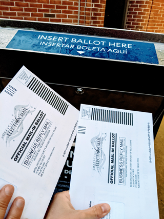 Two mail-in ballots going into ballot box
