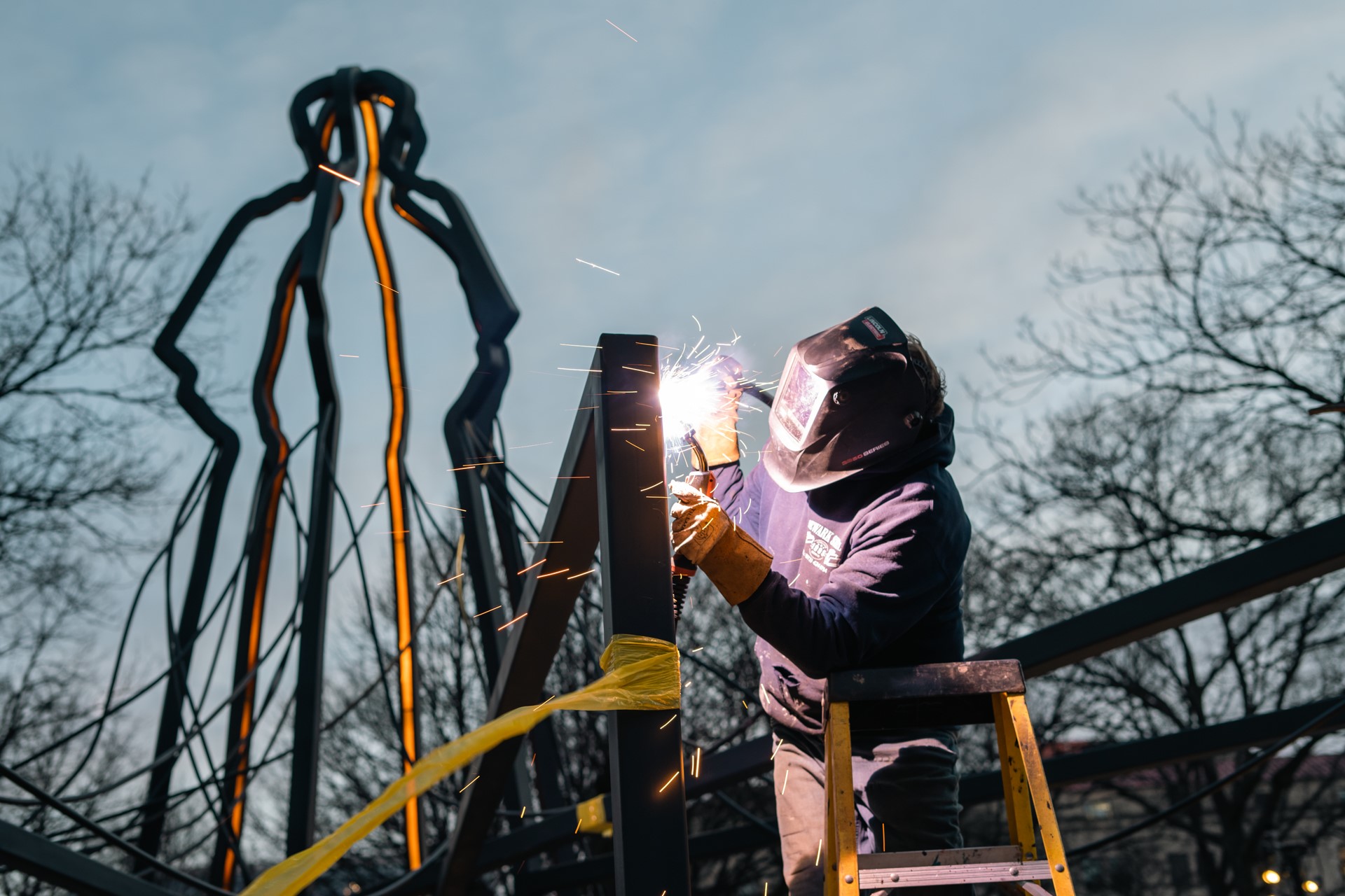 Local artist Charlie Spademan of Gardenship welding the monument
